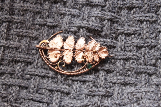 A lightweight resin flower brooch resting on a soft linen fabric, showcasing its intricate craftsmanship.