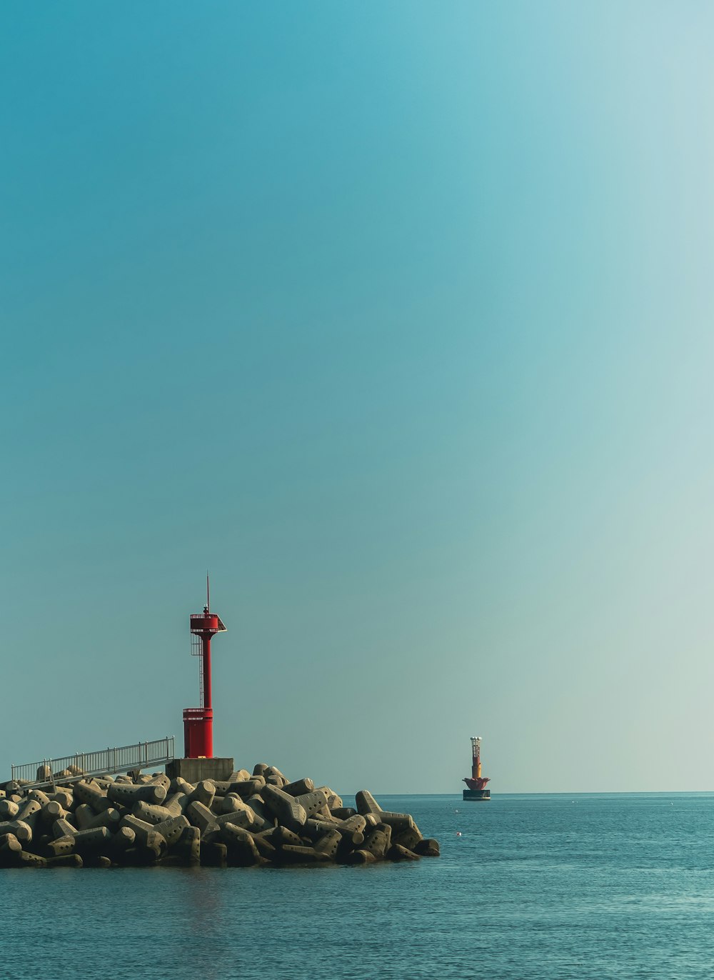 a lighthouse on a rock outcropping in the ocean