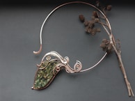 Wire technique details on a Celtic torc displayed in a museum case.