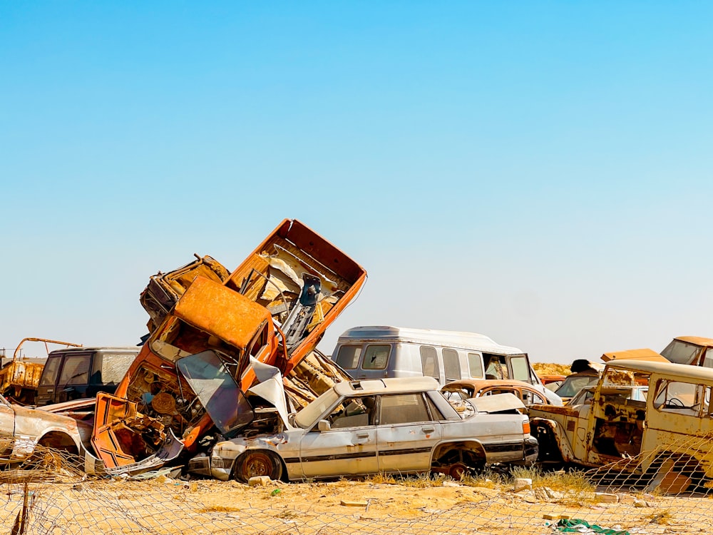 a bunch of cars that are sitting in the dirt