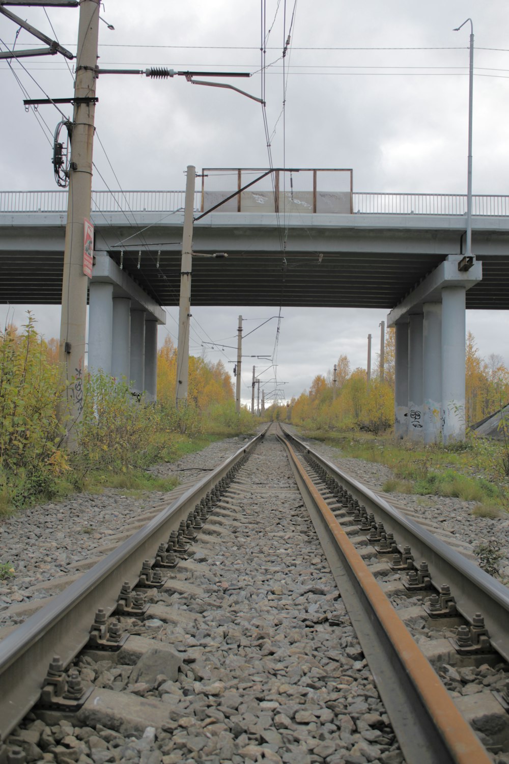 a train track with a bridge in the background