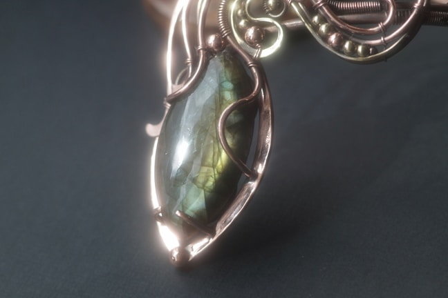 Elegant pendant necklace with a shimmering stone centerpiece.