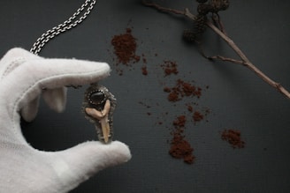 A close-up of a custom corrupted eye pendant glowing softly on a velvet cushion.