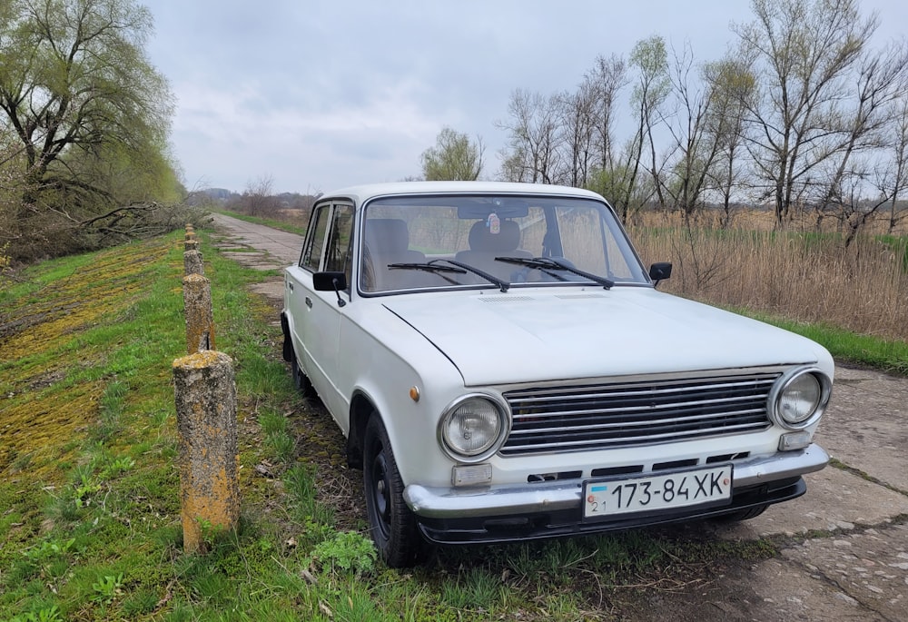 a white car parked on the side of a road