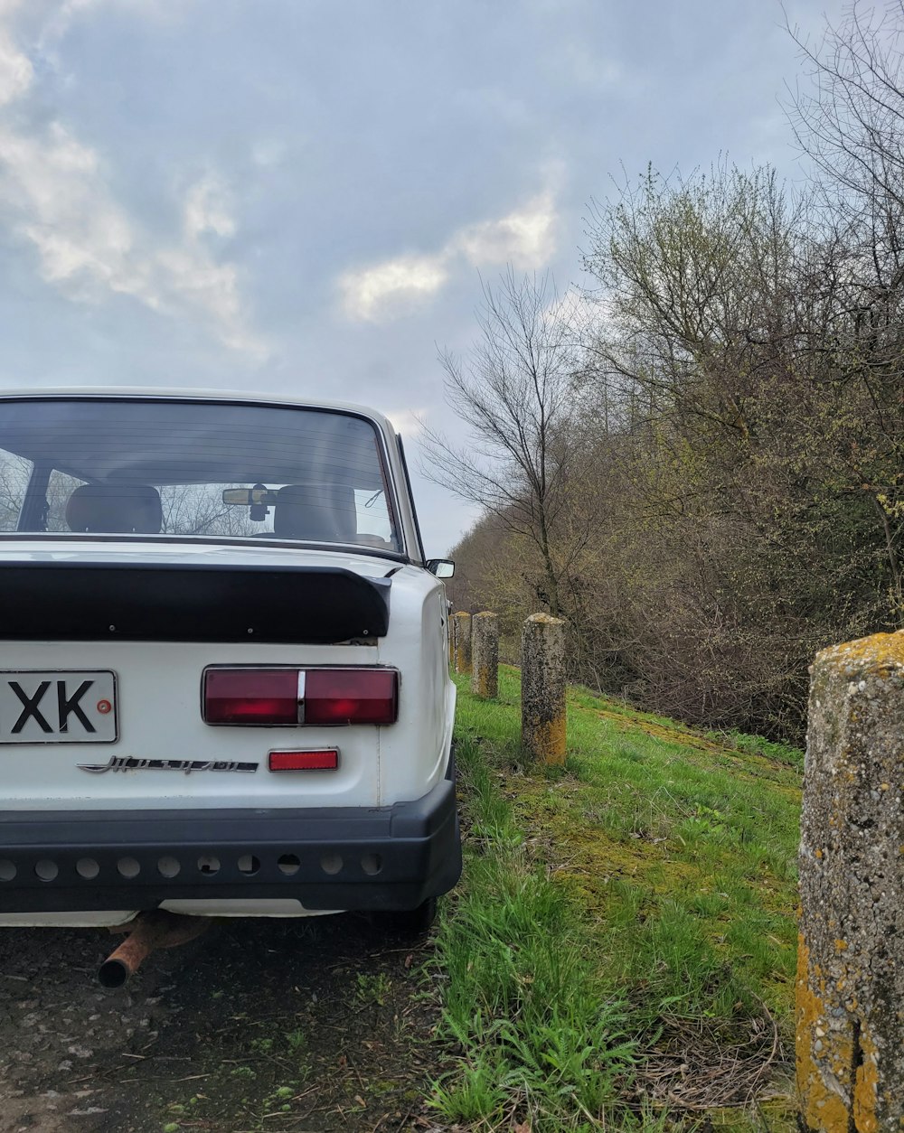 a white car parked on the side of a road