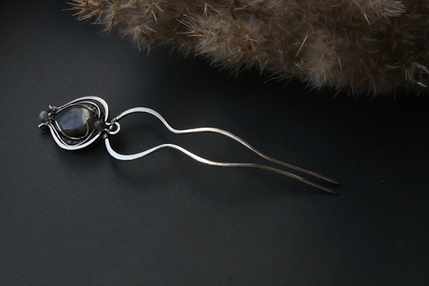 Artisan hair jewelry woven with tiny crystals and natural elements, glowing softly.