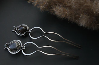 Minimalist crystal hairpins arranged artistically on a velvet background.