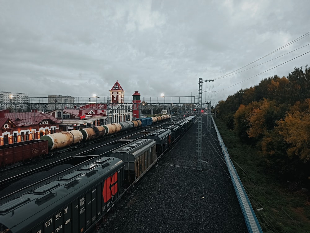 a train yard with several trains on the tracks