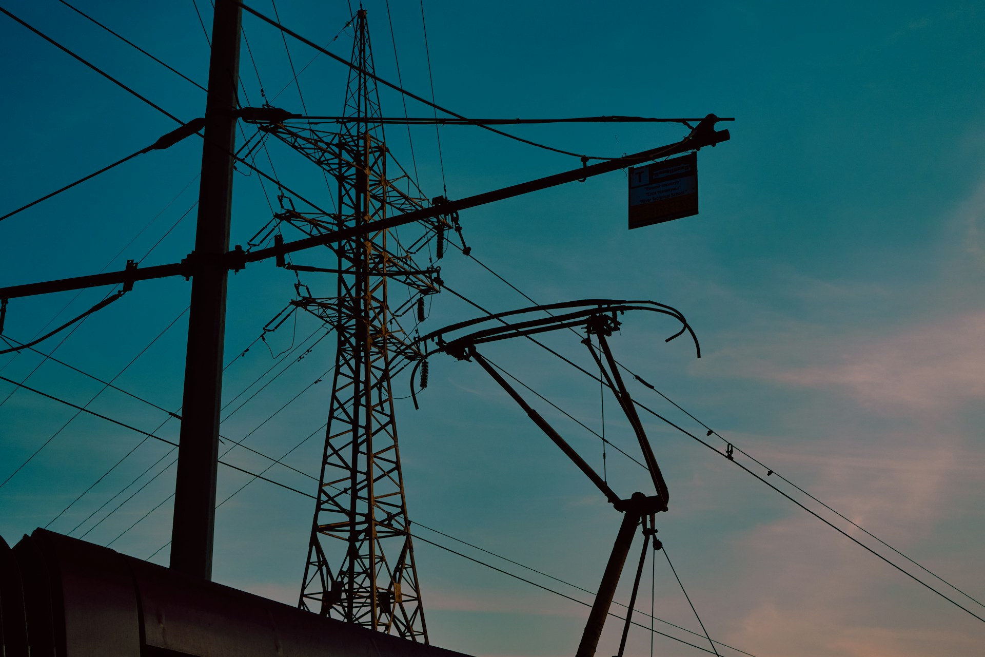 A sunrise shot over a network of power lines and municipal facilities, symbolizing the integration of technical and regulatory elements.