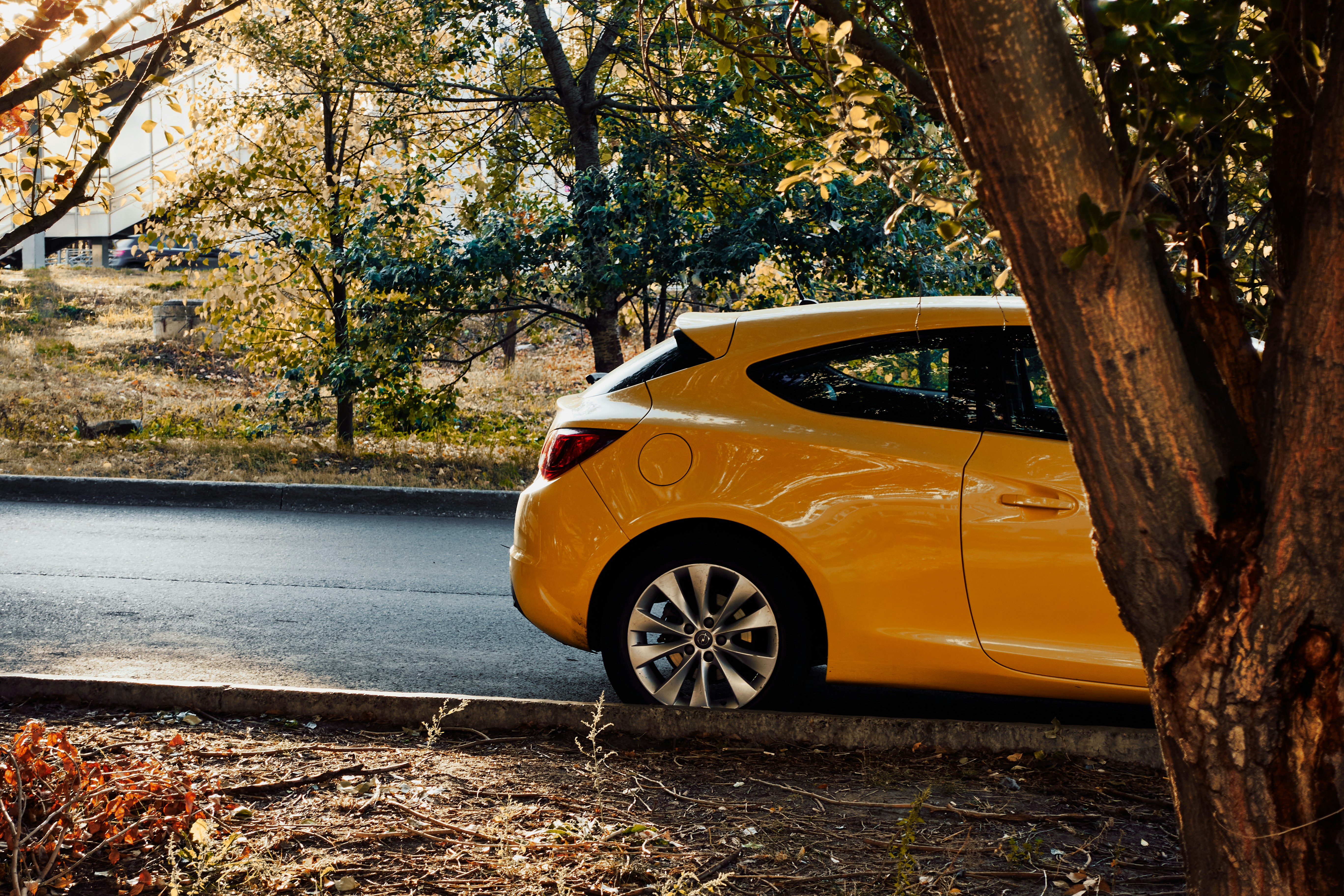 A yellow car parked on the side of the road photo – Free Spoke Image on ...