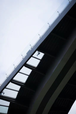 A sleek, modern bridge under construction with AI-driven machinery in action.