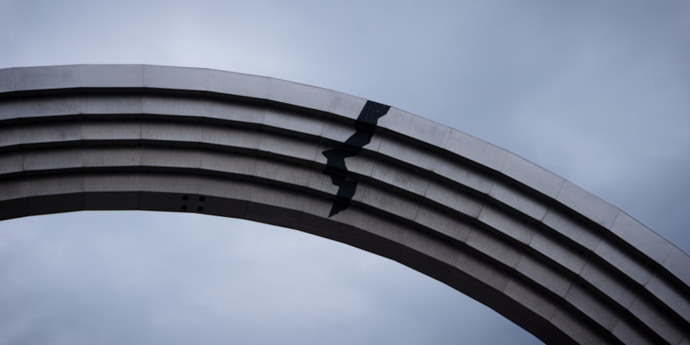 a curved metal arch with two crosses on it