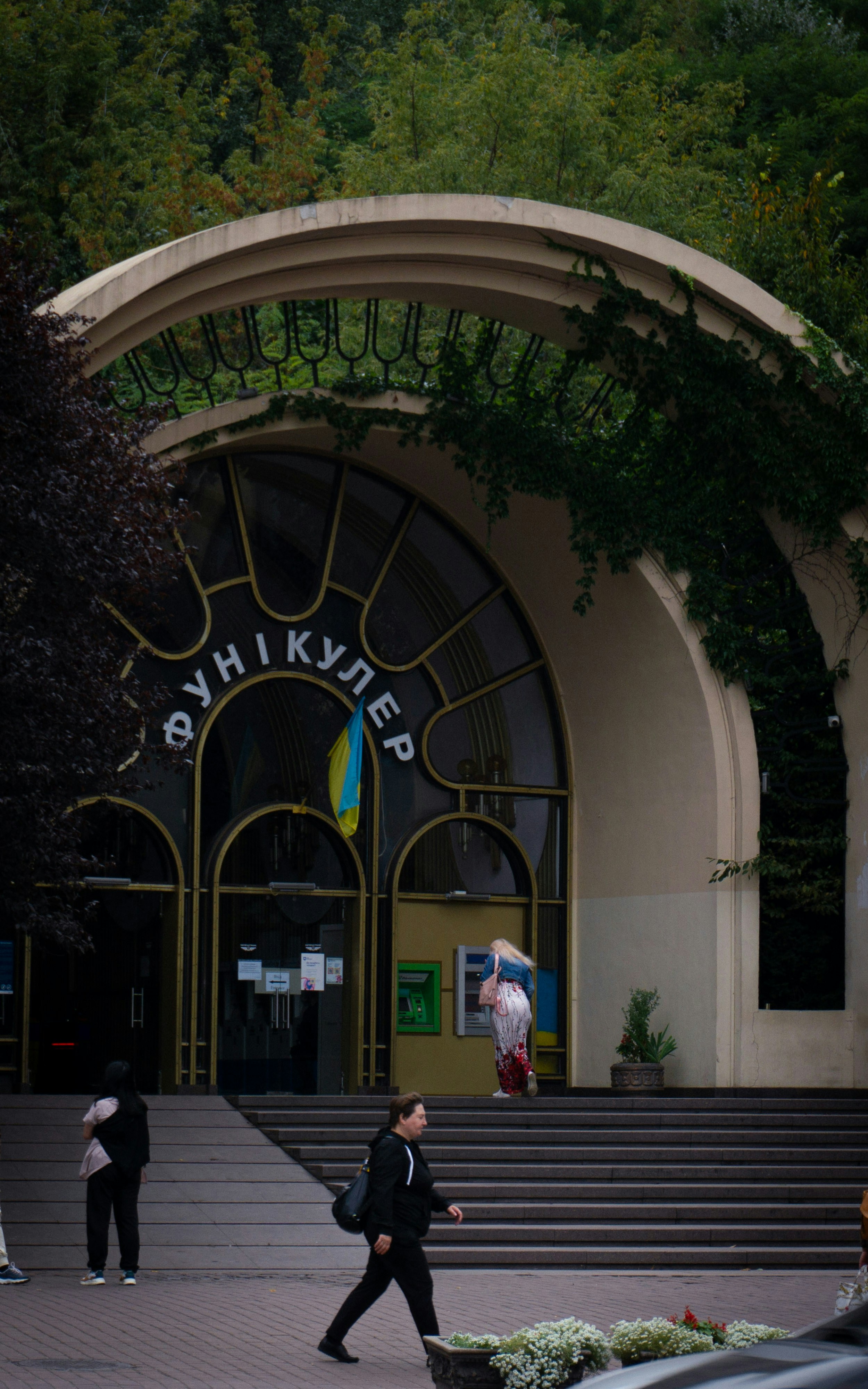 a man in a suit walking in front of a building