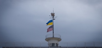 American and Ukrainian flags displayed together on a historic building in Washington, DC.