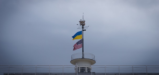 American and Ukrainian flags displayed together on a historic building in Washington, DC.