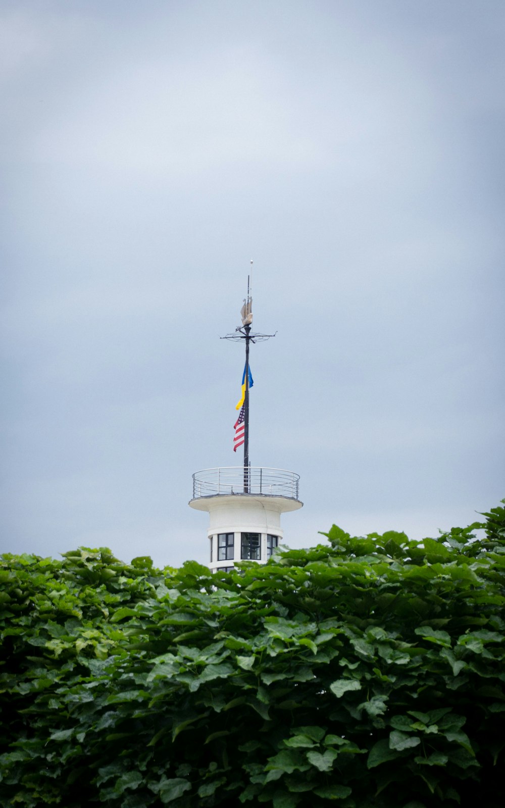 a tall tower with a flag on top of it