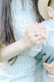 Close-up of matching mommy and baby shirts with delicate patterns.