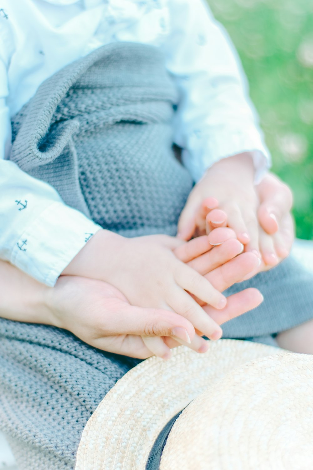 a close up of a person holding a child's hand