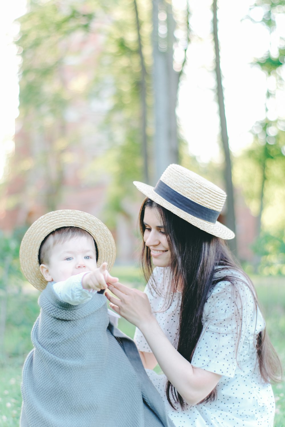 a woman is holding a baby in a blanket