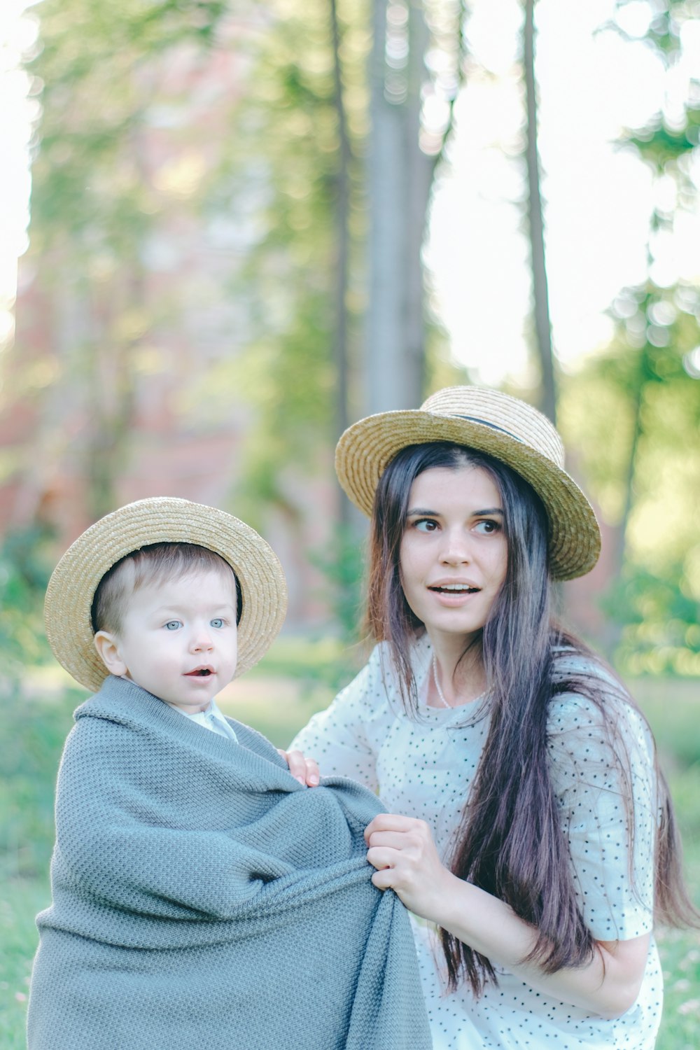 a woman holding a baby wrapped in a blanket