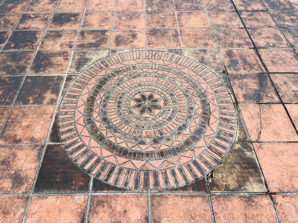 a circular design on a brick floor in the middle of a courtyard
