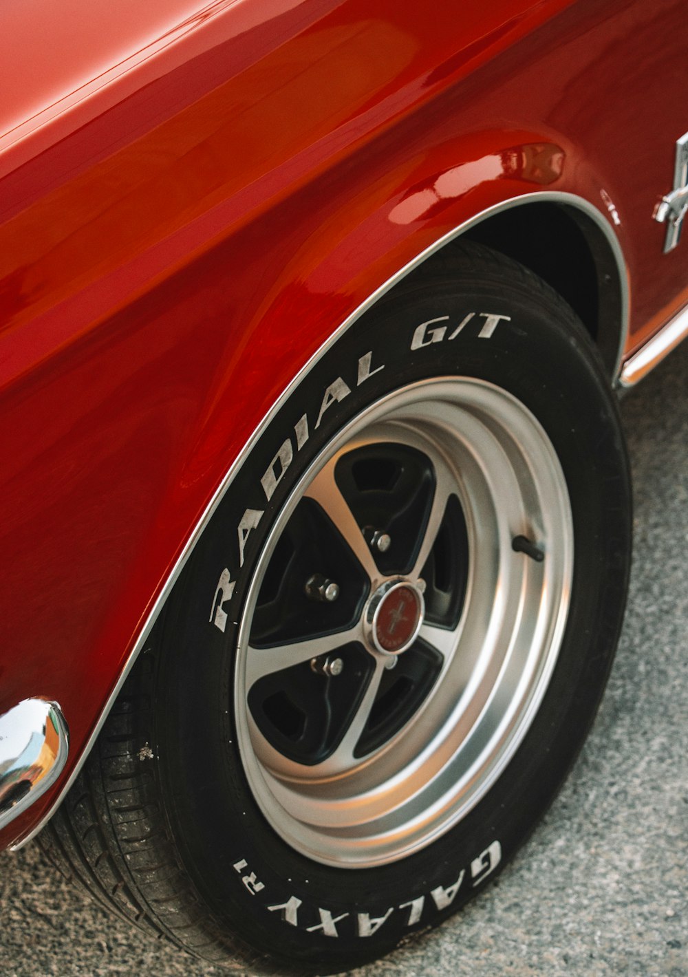 a close up of a red car's tire