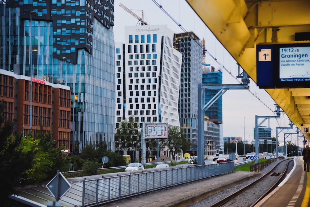 a view of a train track and some tall buildings