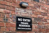 Secure home entrance with visible CCTV cameras and alarm system signage.