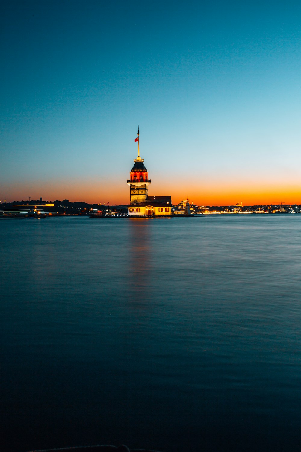 a large body of water with a clock tower in the background