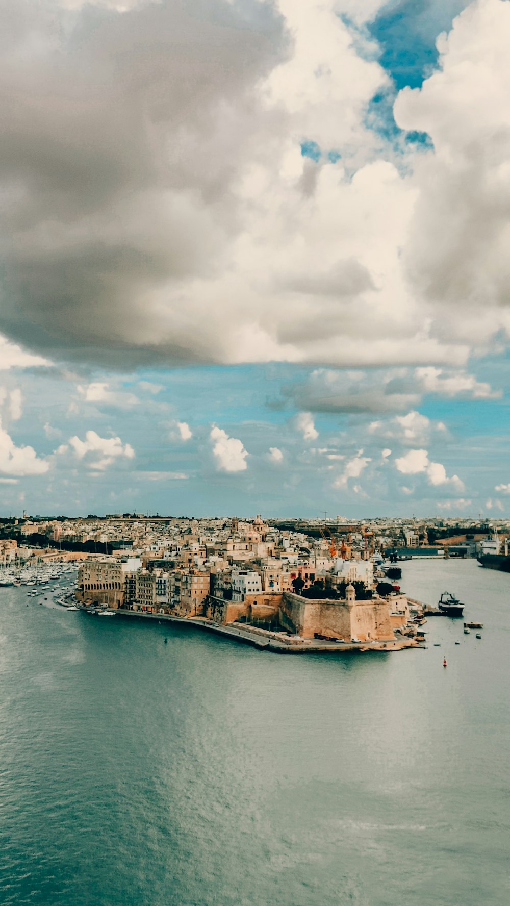 a large body of water with a city in the background