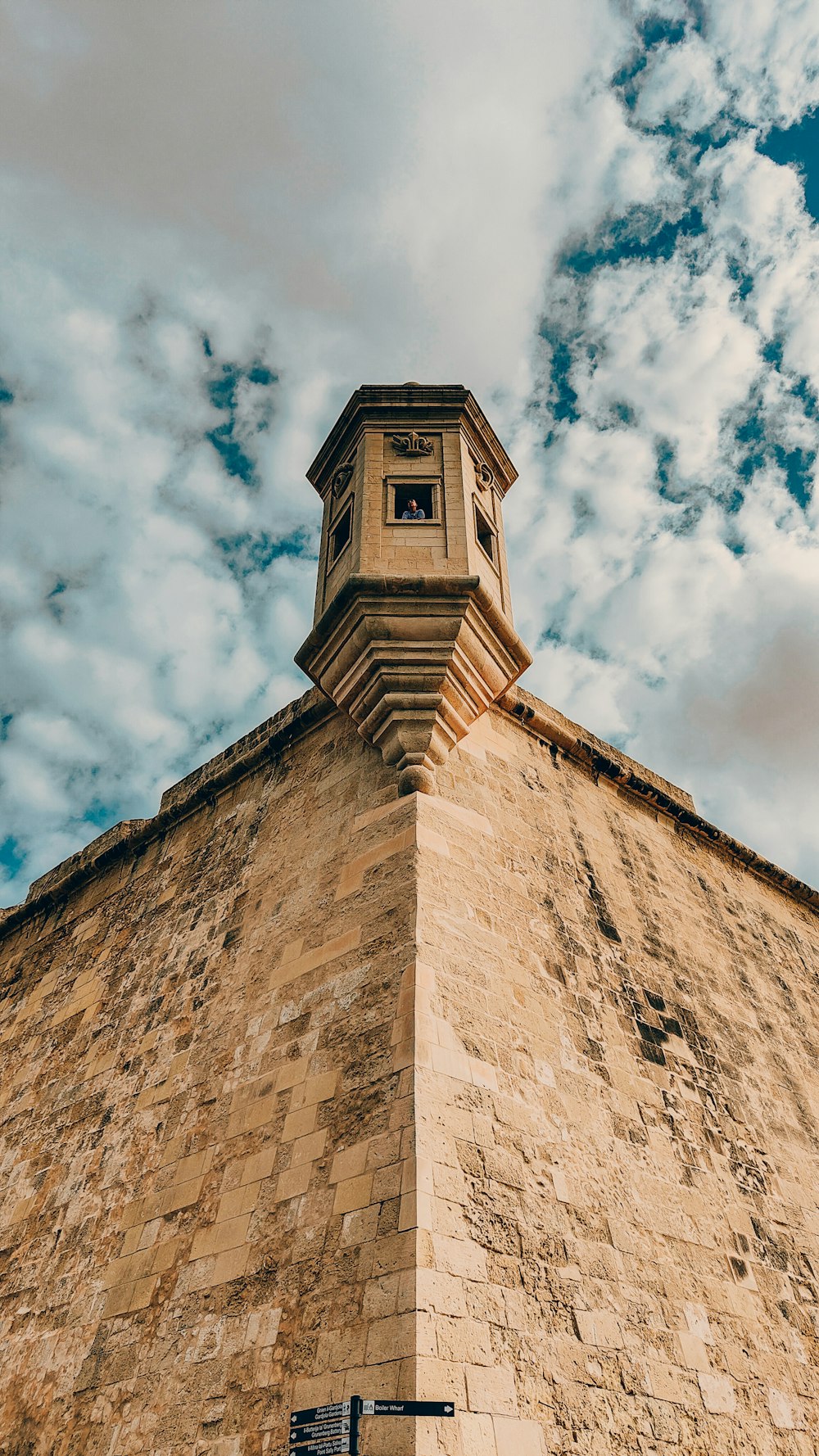 a tall brick building with a clock on the top of it