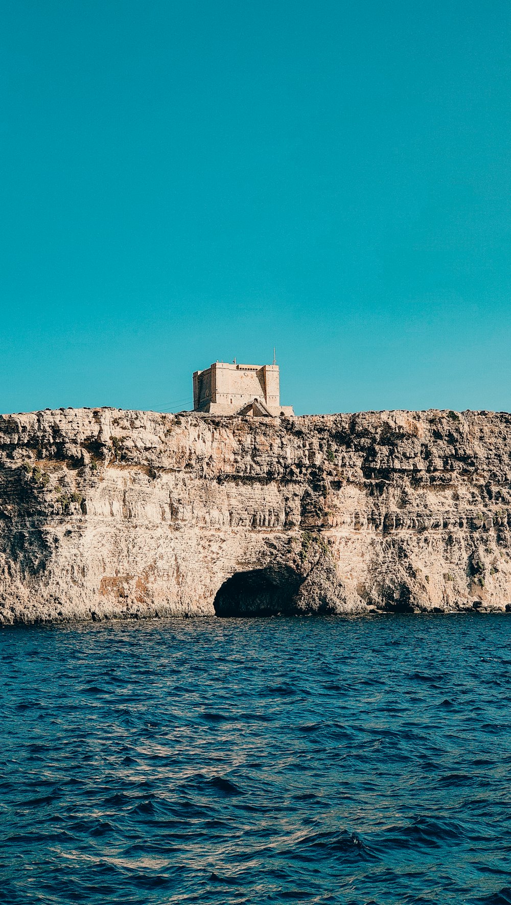 a building on top of a cliff over a body of water