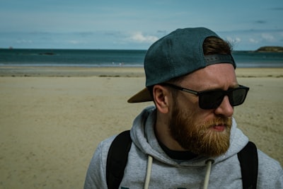 a man with a beard wearing a hat and sunglasses