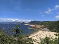 A picturesque view of a serene ocean with colorful beach umbrellas.
