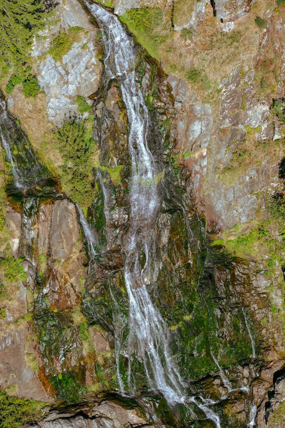 a small waterfall in the middle of a rocky area