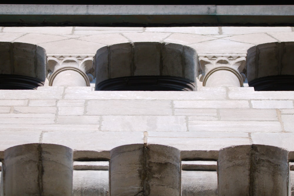 a close up of a brick wall with a row of round windows