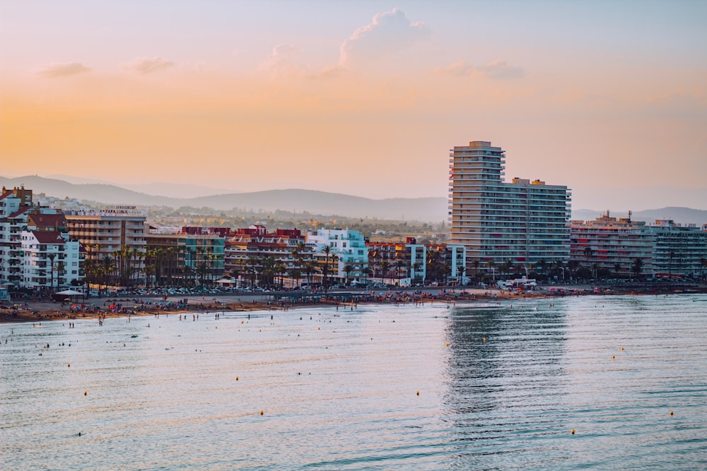 a body of water with buildings in the background