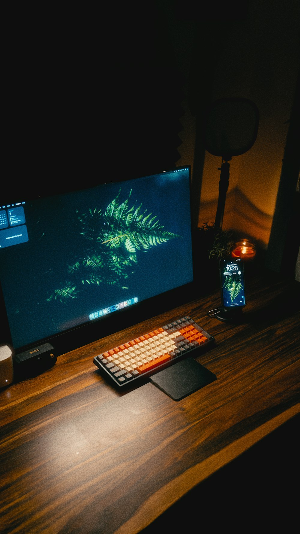 a computer monitor sitting on top of a wooden desk