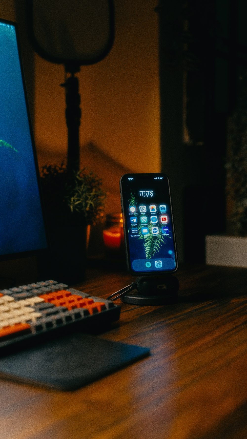 a cell phone sitting on top of a desk next to a keyboard