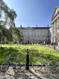 two bikes parked next to each other in front of a building