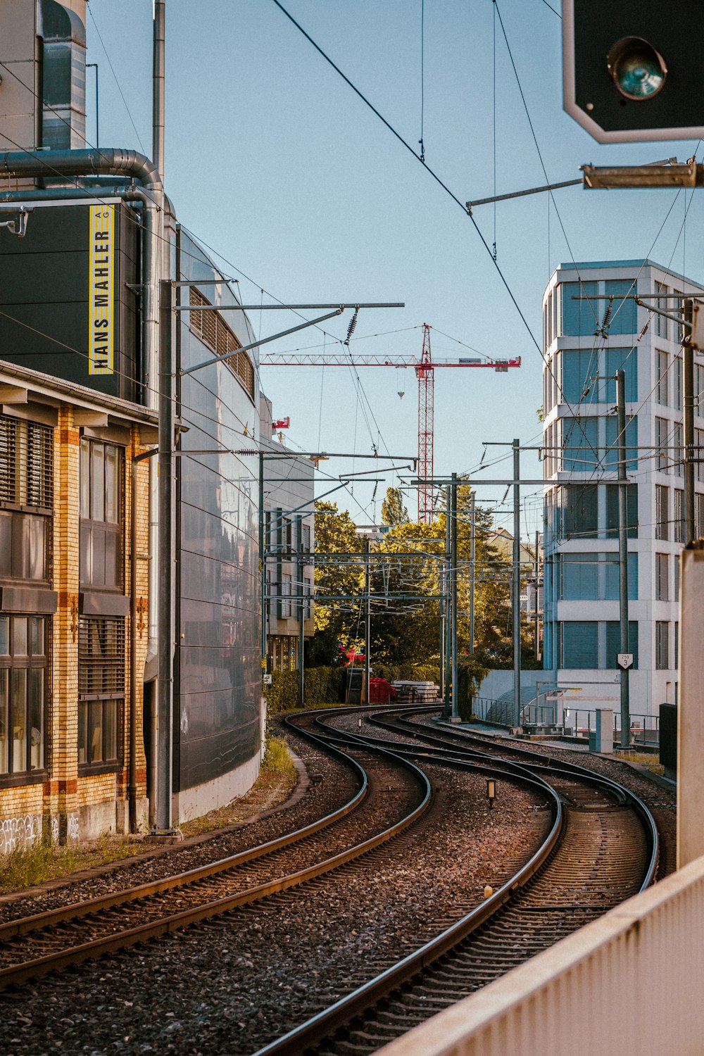 a view of a train track with a building in the background