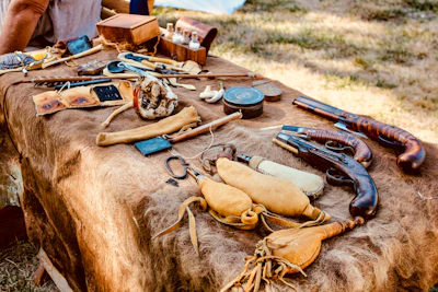 Historic photographs and artifacts displayed on a wooden table.