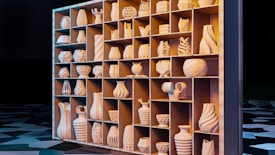 A large shelving unit holds an assortment of intricately designed vases and pottery, each with unique geometric patterns and shapes. The lighting casts a warm glow on the shelves, highlighting the curves and details of the ceramics. The background features a patterned, dark surface creating a contrast with the illuminated objects.