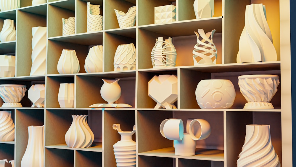 a shelf filled with lots of white vases