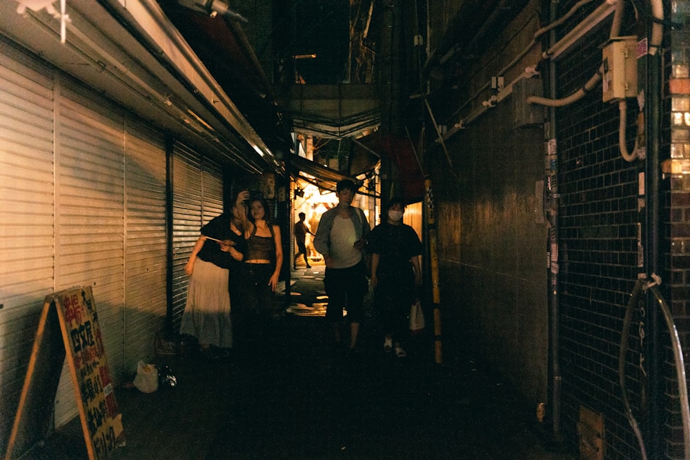 a group of people standing in a narrow alley