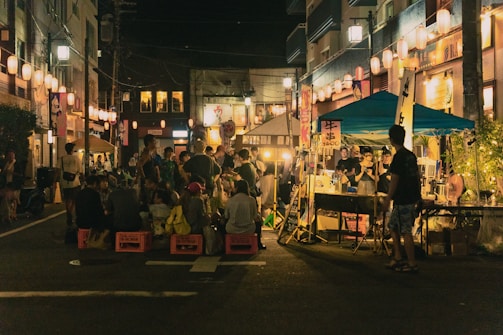Bustling night market in Singapore glowing with lanterns and street food stalls.