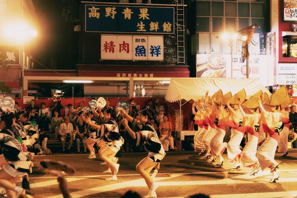 a group of people that are standing in the street