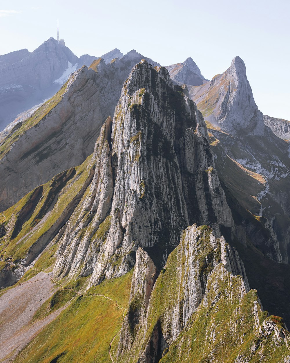 a very tall mountain with some very pretty green grass