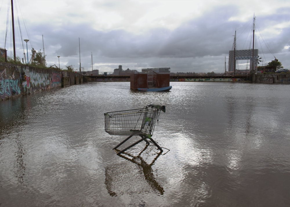 a shopping cart sitting in the middle of a flooded street