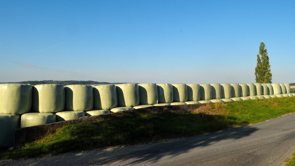 a long row of bales sitting on the side of a road